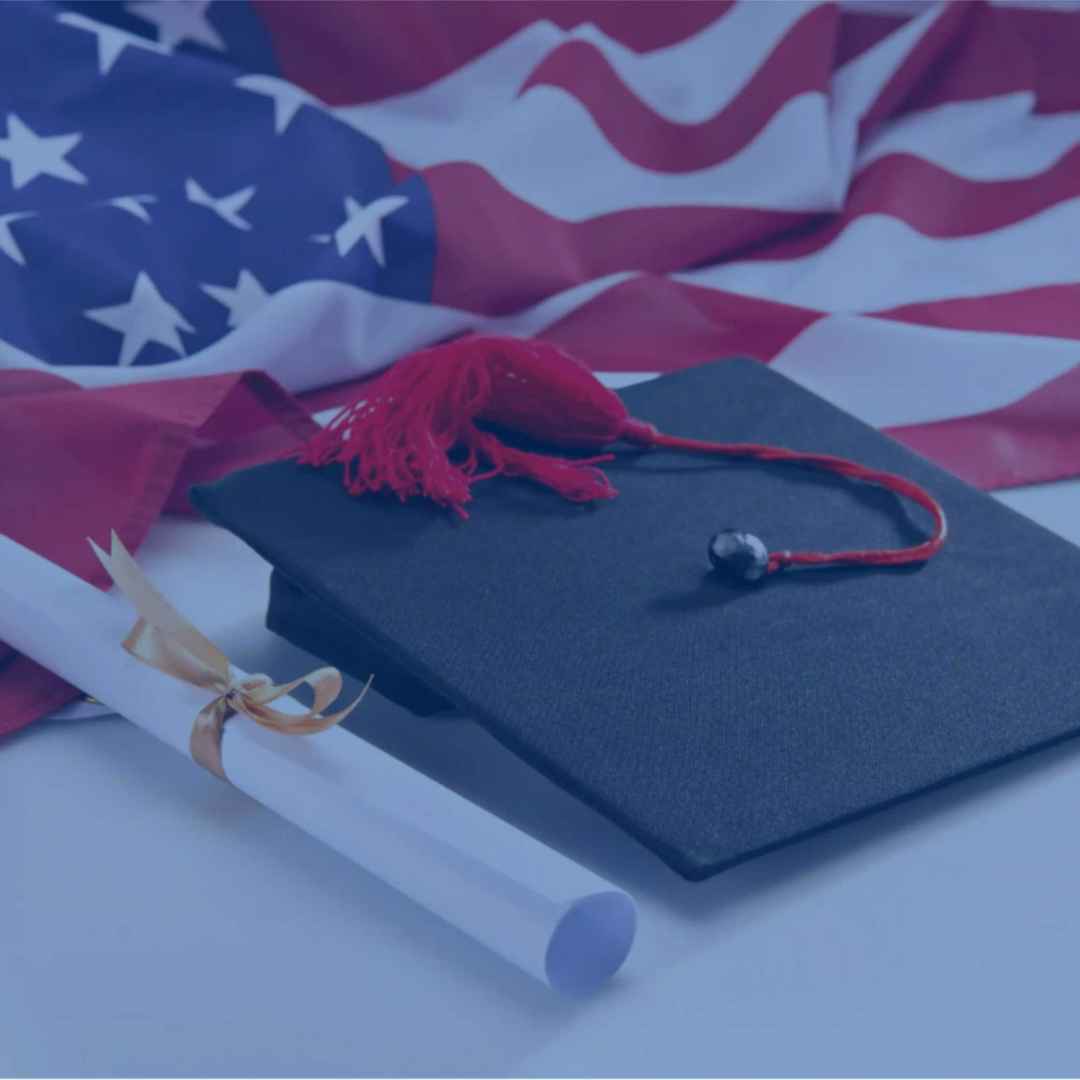 Graduation hat and diploma on USA flag.